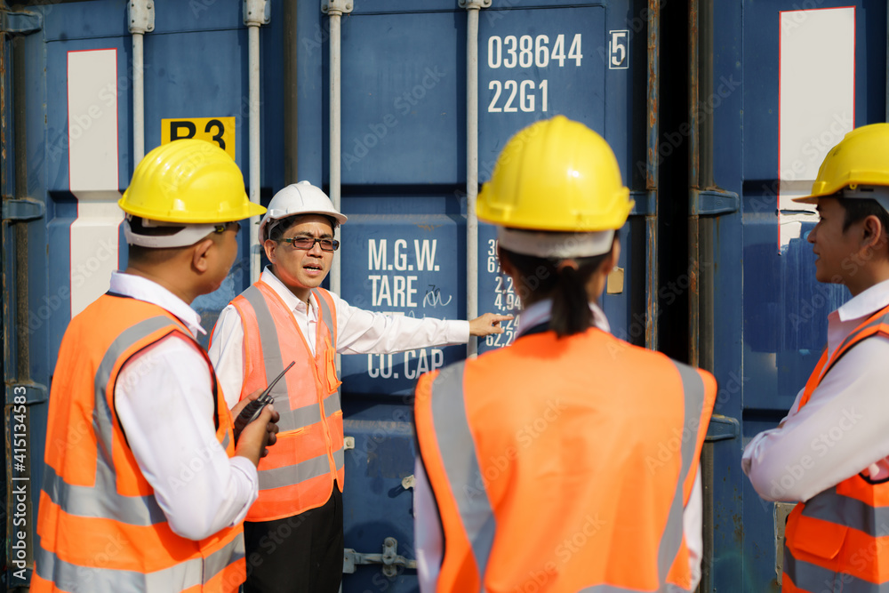 Asian foreman is explaining and teaching new training workers for various components of container to