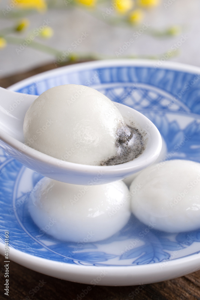 Close up of yuanxiao tangyuan in a bowl on gray table, food for Chinese Lantern Yuanxiao Festival.