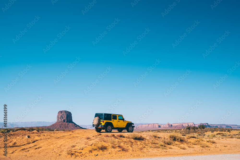 Sport utility vehicle driving off road in Monument Valley