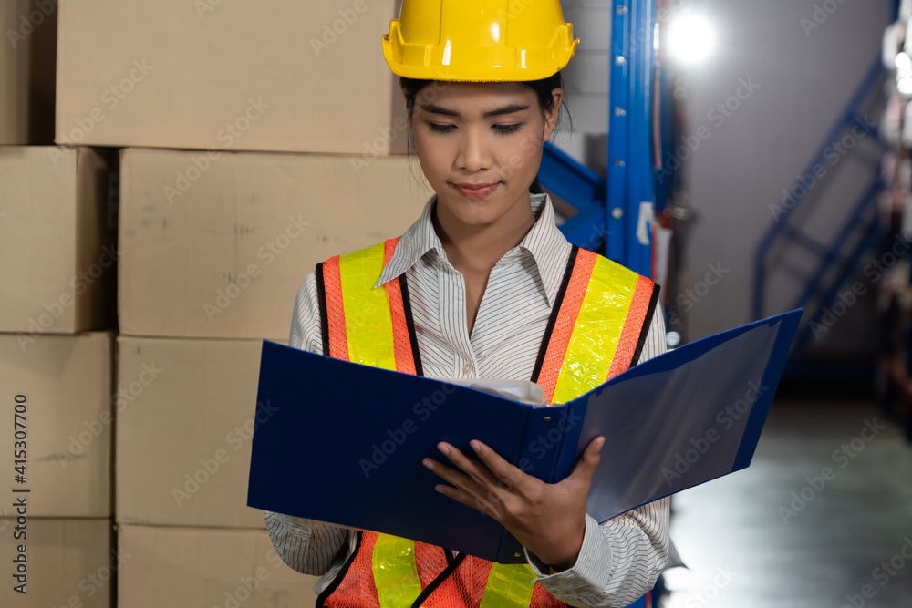 Female warehouse worker working at the storehouse . Logistics , supply chain and warehouse business 