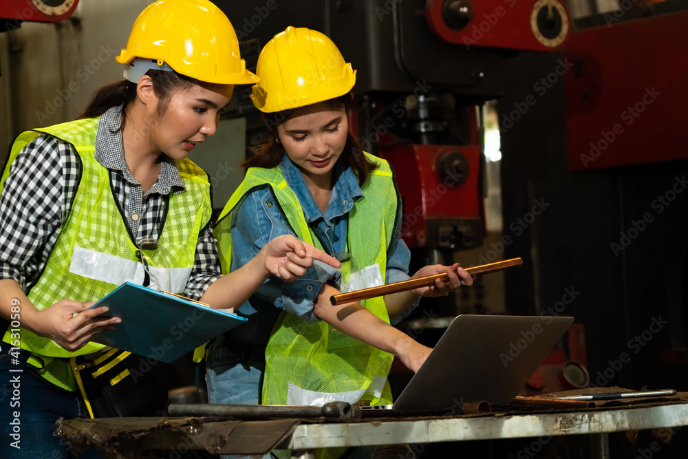 Factory job workers working and discussing manufacturing plan in the factory . Industry and engineer