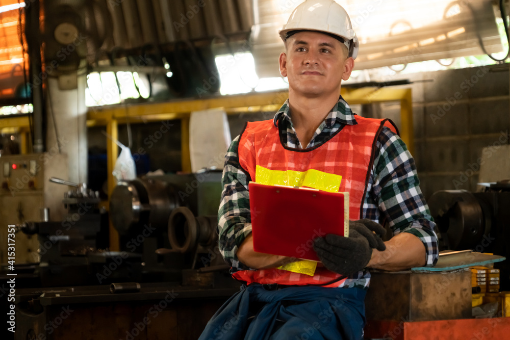 Manufacturing worker working with clipboard to do job procedure checklist . Factory production line 