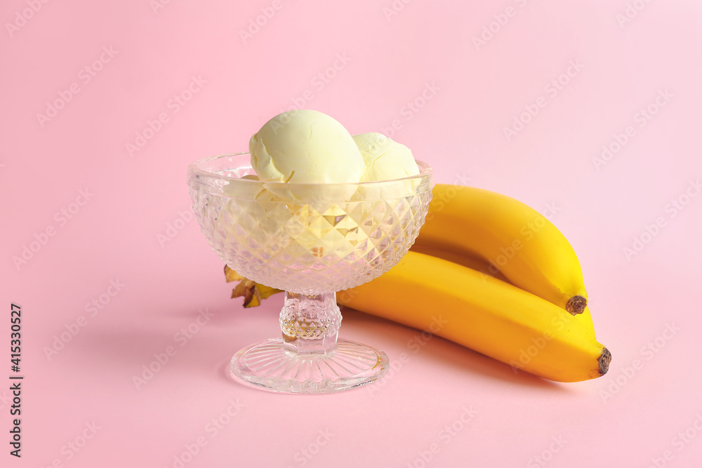 Glass bowl of ice-cream with bananas on color background