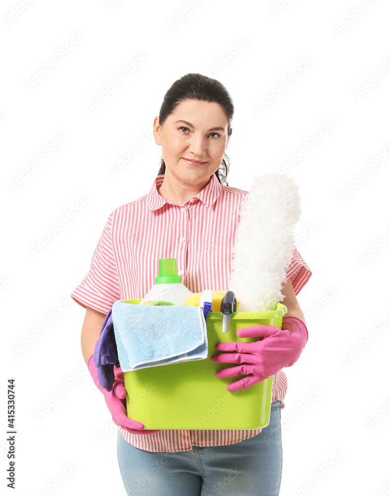 Mature woman with cleaning supplies on white background