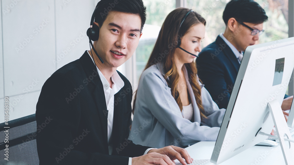 Business people wearing headset working in office to support remote customer or colleague. Call cent