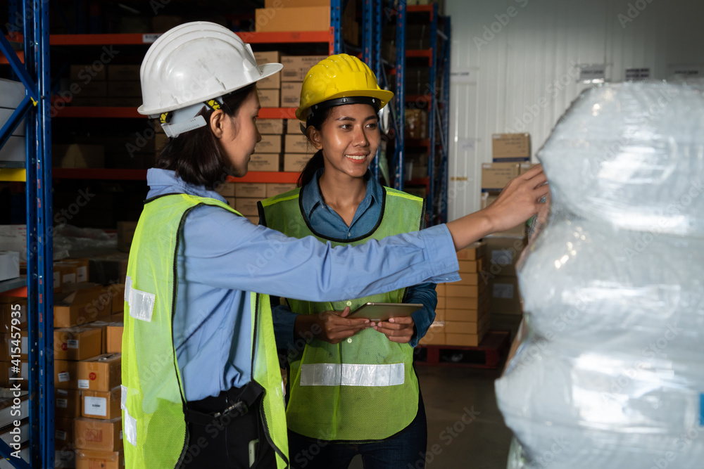 Female warehouse worker working at the storehouse . Logistics , supply chain and warehouse business 