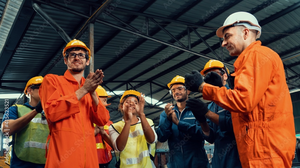 Skillful worker celebrate success in the factory . Industrial people and manufacturing labor concept