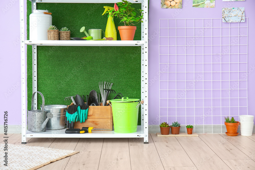 Set of gardening supplies and houseplants in barn