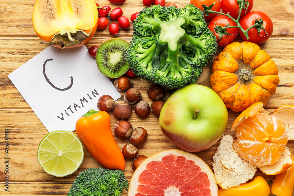 Healthy products rich in vitamin C on wooden background