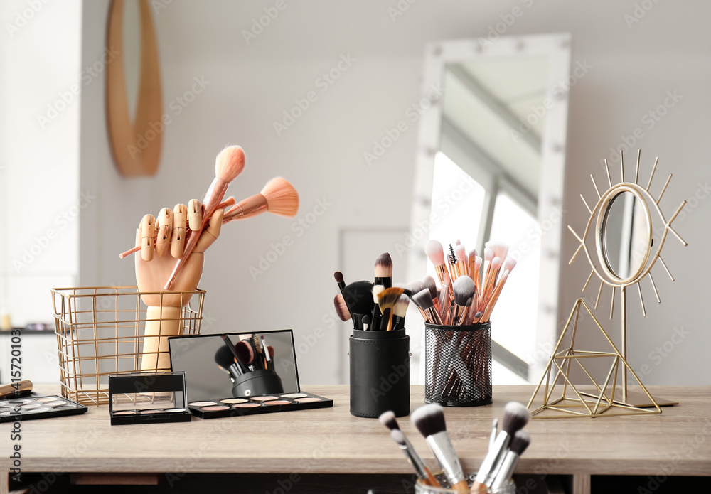 Set of makeup brushes on table in beauty salon