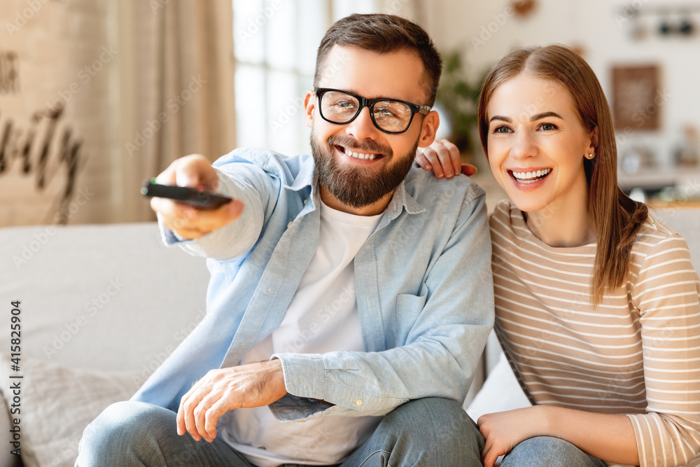 Happy couple watching TV together