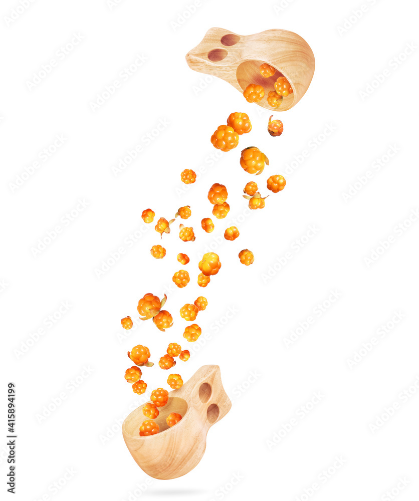 Cloudberries are flying out from a wooden cups, isolated on a white background