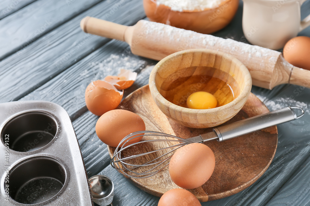 Set of kitchen utensils and ingredients for bakery on dark wooden background, closeup