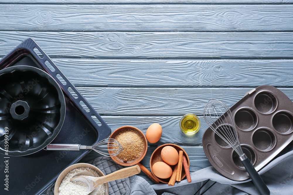 Set of kitchen utensils and ingredients for preparing bakery on dark wooden background