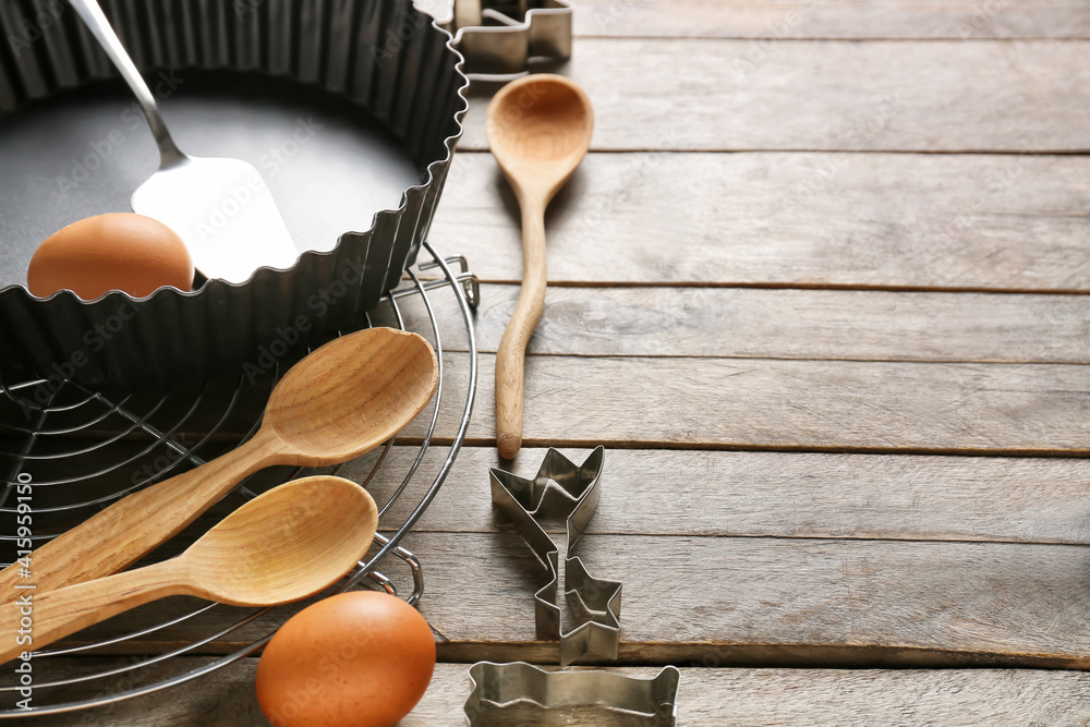 Set of kitchen utensils and ingredients for preparing bakery on wooden background, closeup