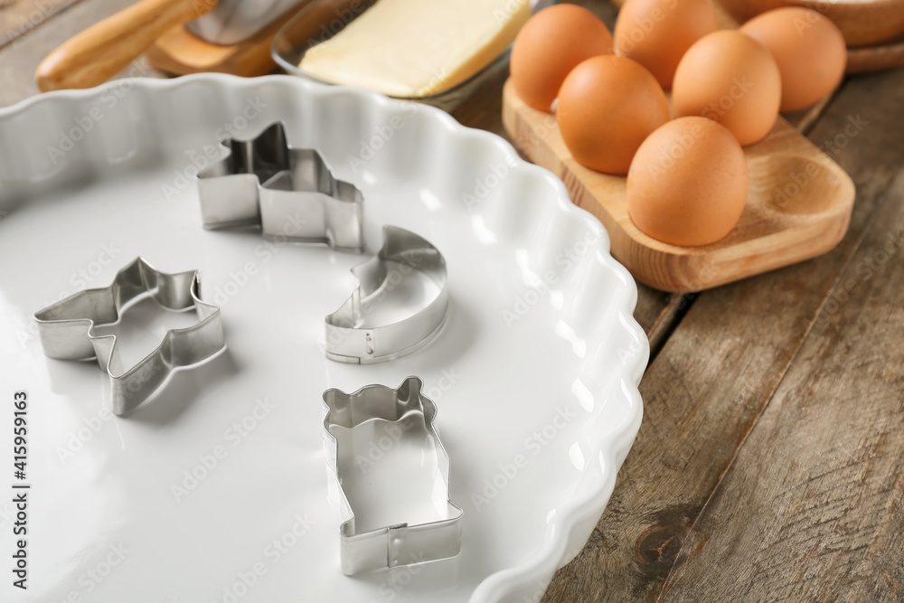 Set of kitchen utensils and ingredients for preparing bakery on wooden background, closeup