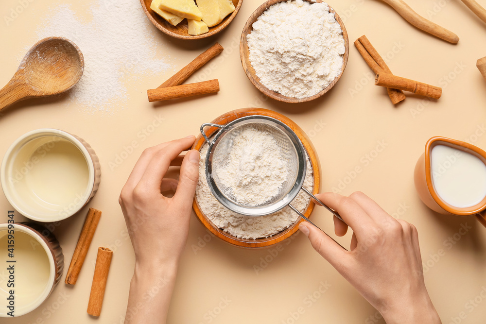 Woman preparing dough on color background