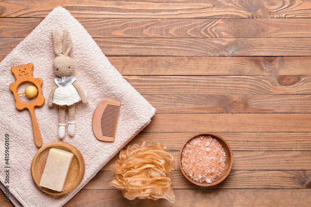 Set of bath accessories for baby on wooden background