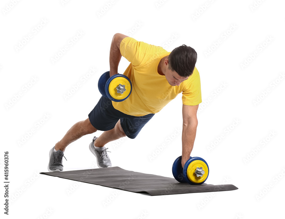 Sporty young man training with dumbbells on white background