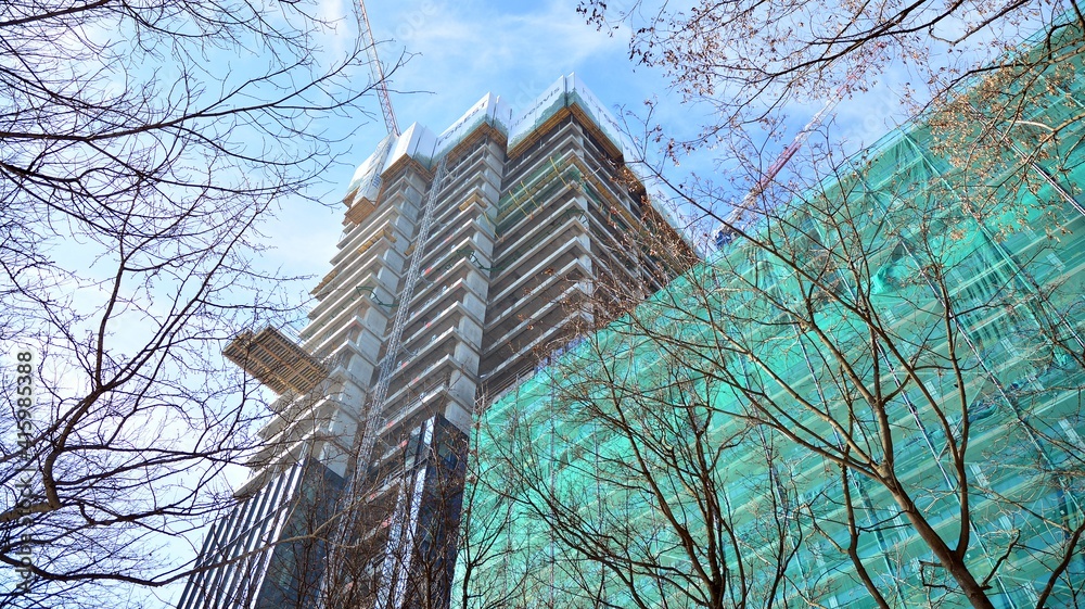 View of a skyscraper under construction. Modern architecture background. Building a high-rise buildi