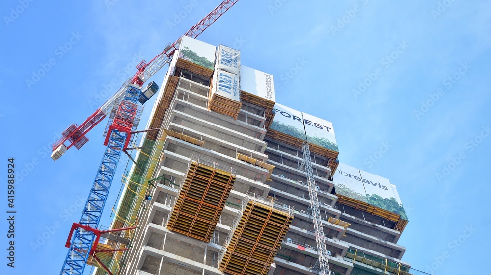 View of a skyscraper under construction. Modern architecture background. Building a high-rise buildi