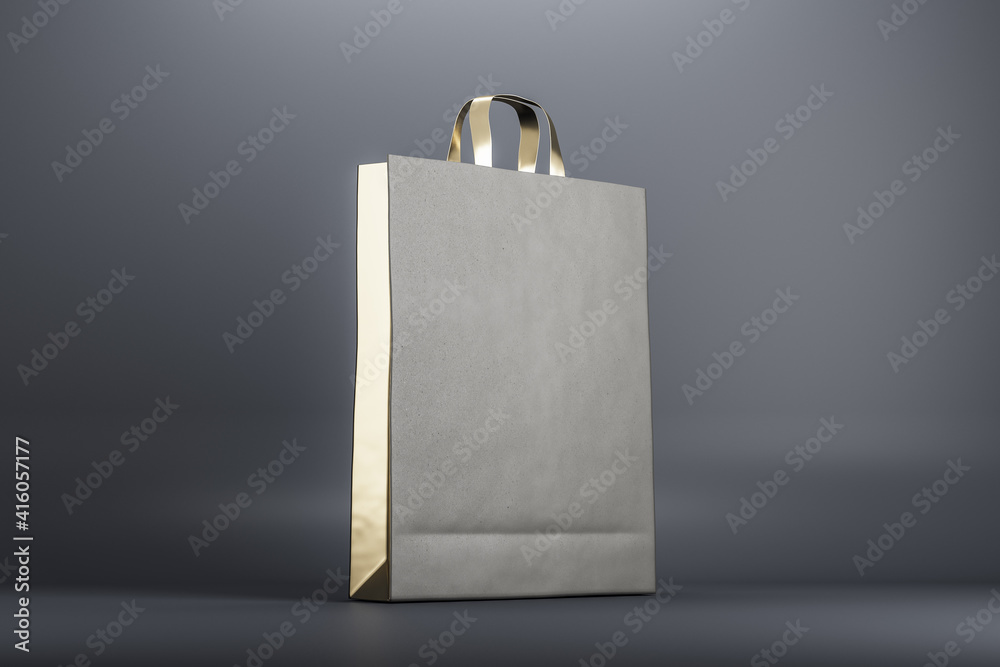 Eco friendly recycled paper bag with golden elements at abstract grey background. Mock up