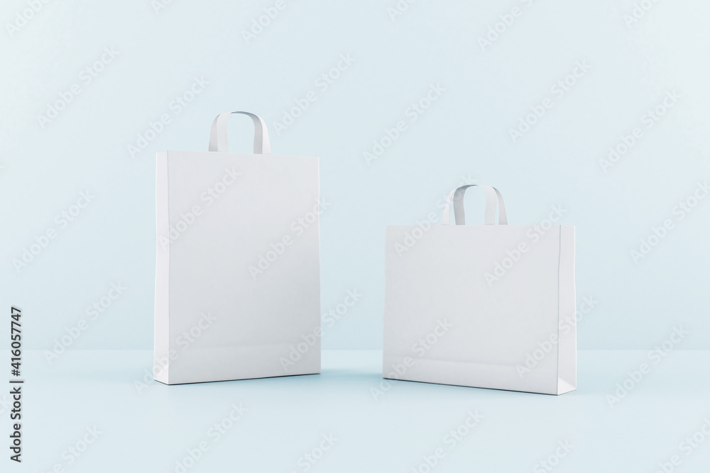 Blank white eco paper bags with a space for your logo at blue background. Mock up