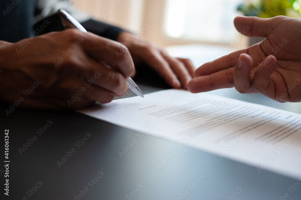 Close-up the signing of the contract agreement document.