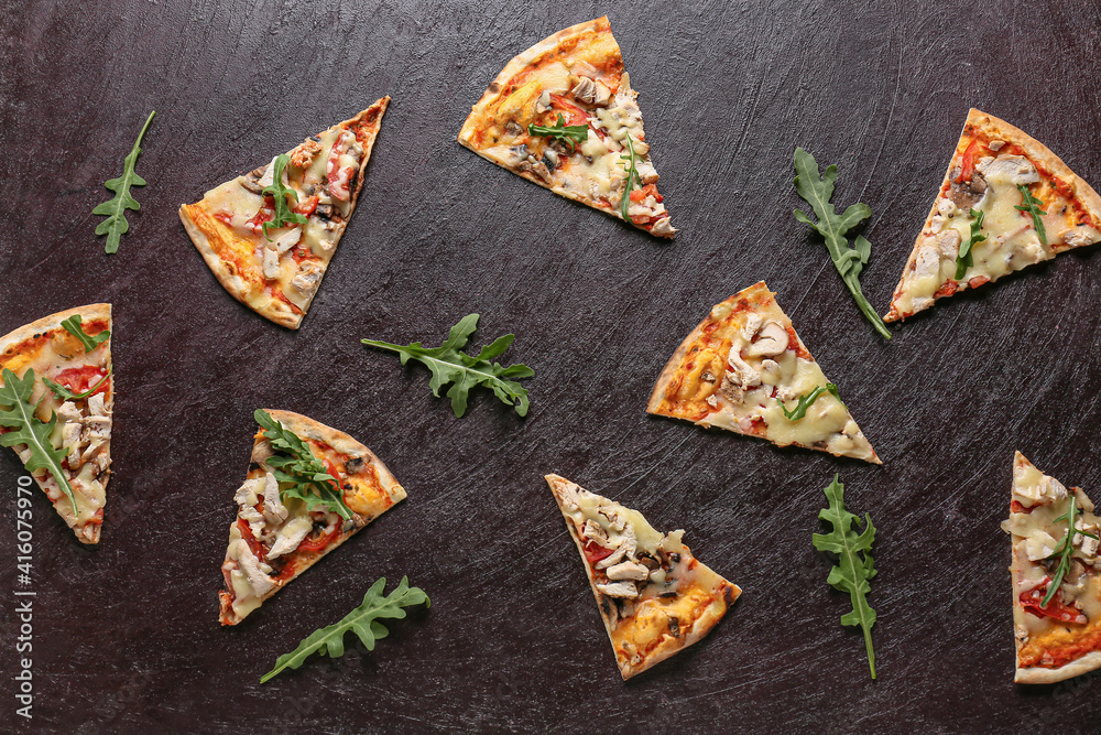 Slices of tasty pizza on dark background