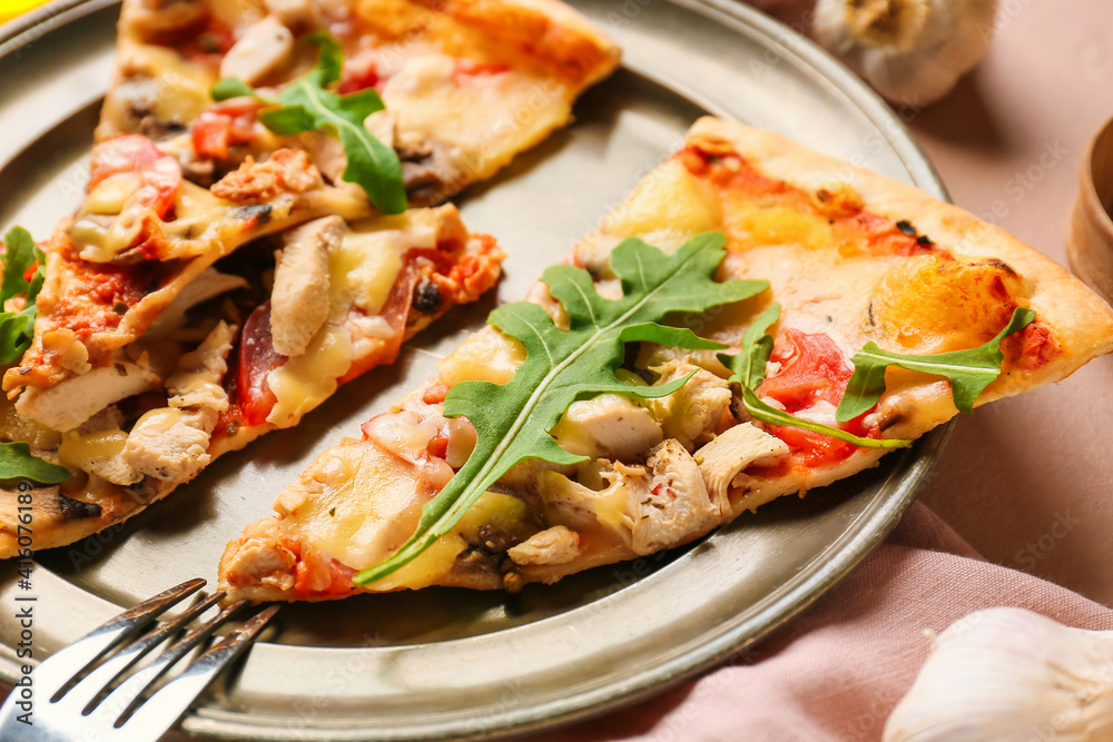 Plate with slices of tasty pizza on color background