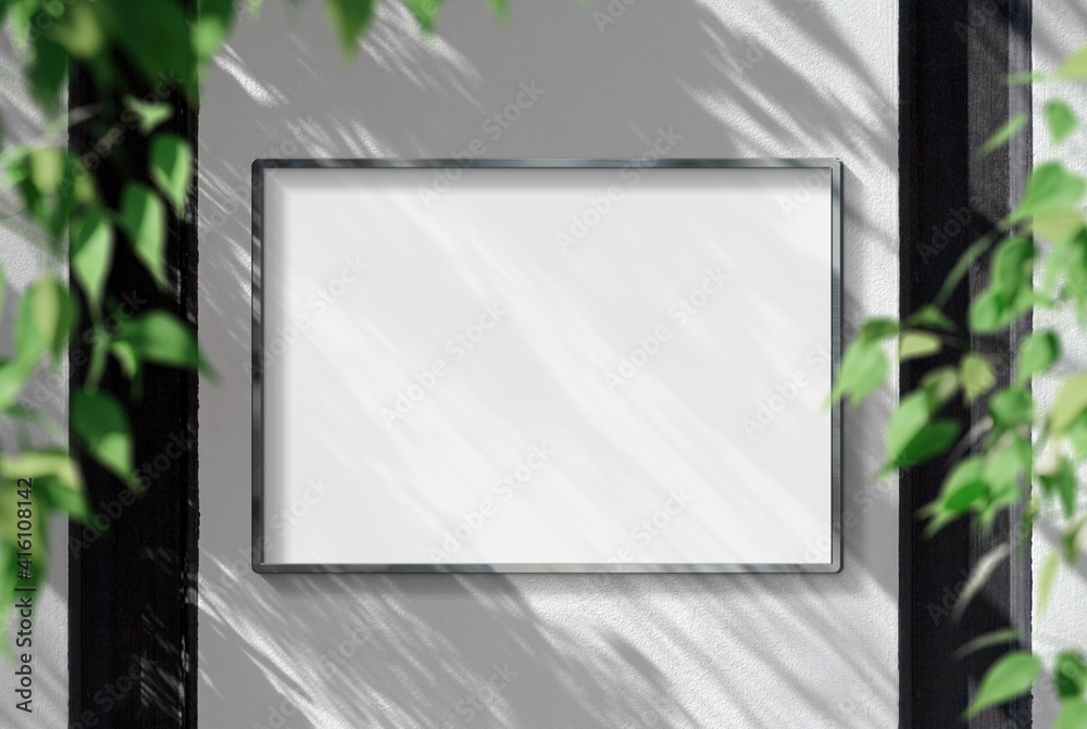 Metal frame hanging in street mockup. Template of a picture framed on a wall bathed in sunlight 3D r