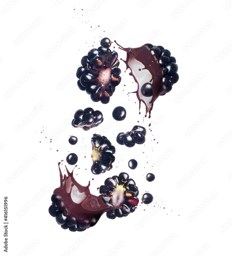 Blackberries crushed in the air with splashes of juice on a white background