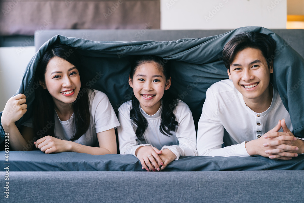 Happy Asian family portrait with mother, father and daughter