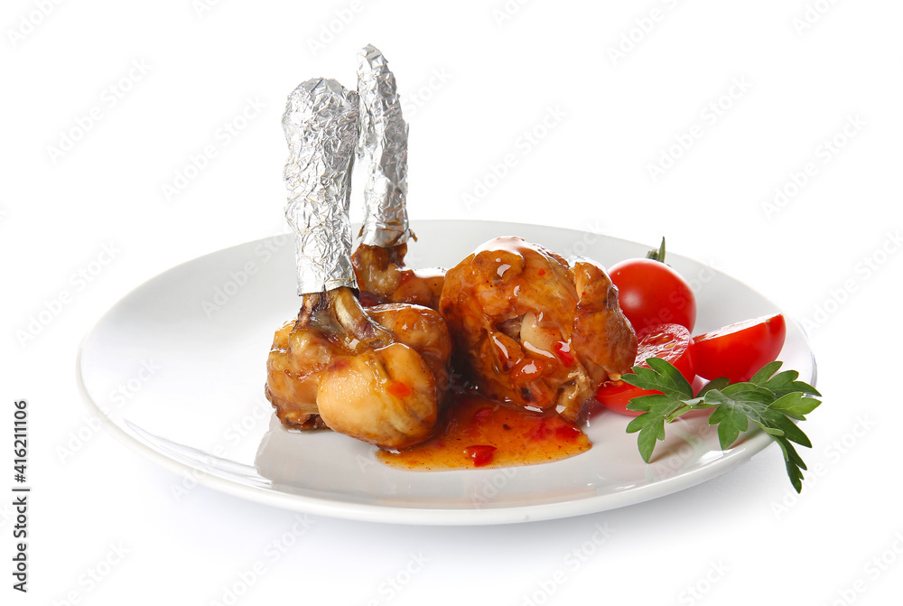 Plate with tasty chicken lollipops on white background