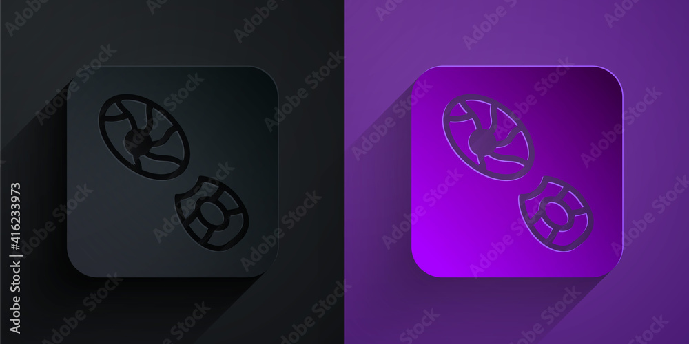 Paper cut Human footprints shoes icon isolated on black on purple background. Shoes sole. Paper art 