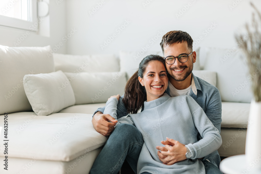 Brunette woman and man with glasses on.