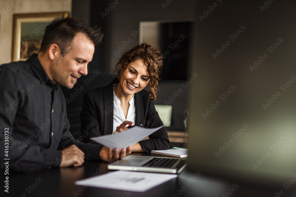 Holding one document, reading.