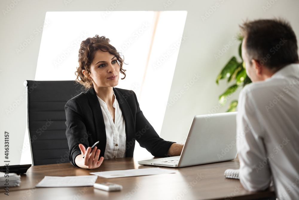 Charming manager talking to an employee, portrait.