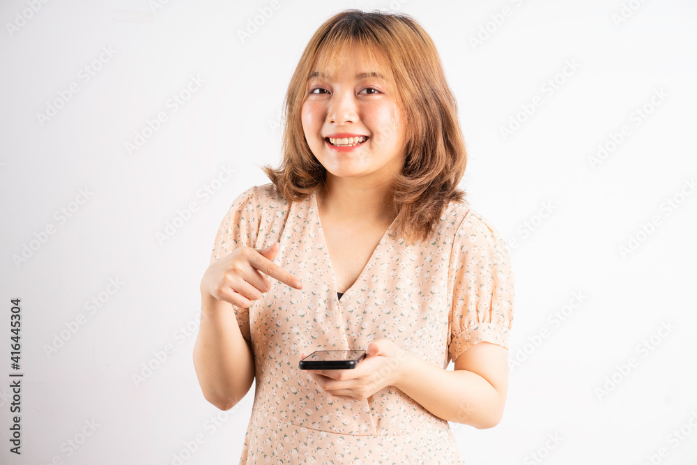 Young asian girl holding phone with expressions, gestures on background