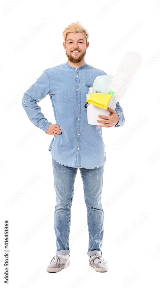 Young man with cleaning supplies on white background