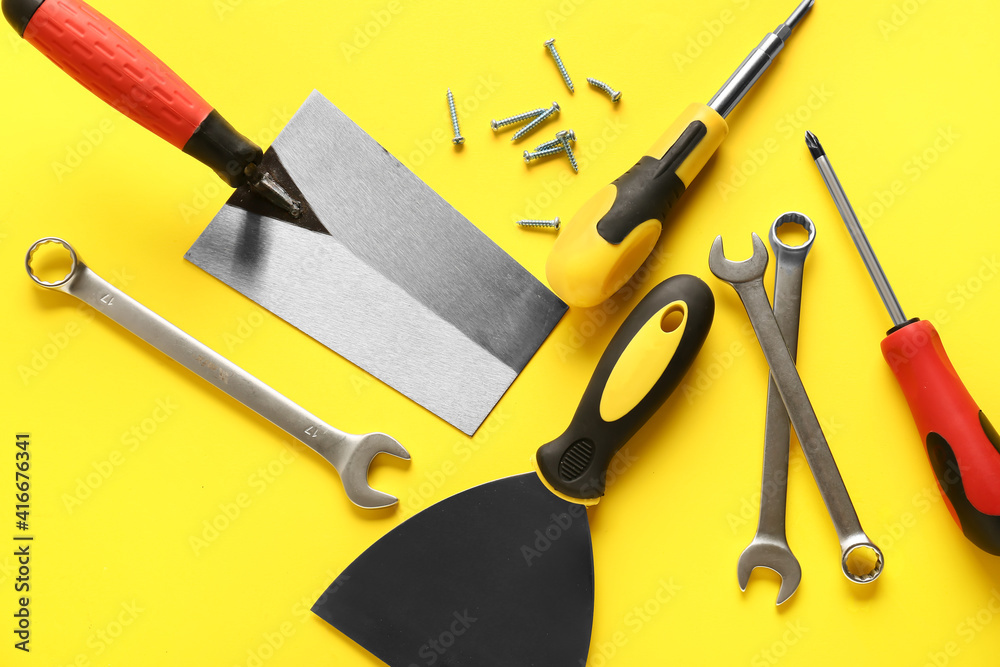 Set of construction tools on color background