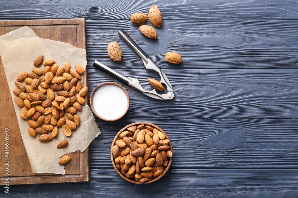 Composition with tasty almonds on wooden background