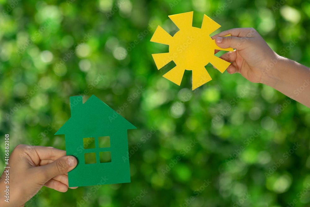 Eco house in children`s hands