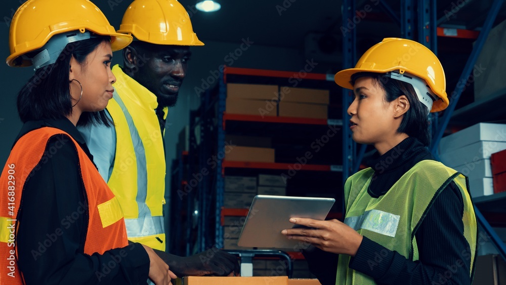 Warehouse worker working together in the storehouse . Logistics , supply chain and warehouse busines