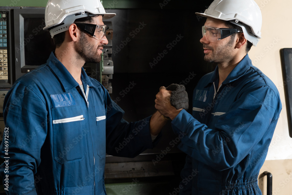 Two skillful factory engineer or worker showing teamwork and partnership . Industrial people and man