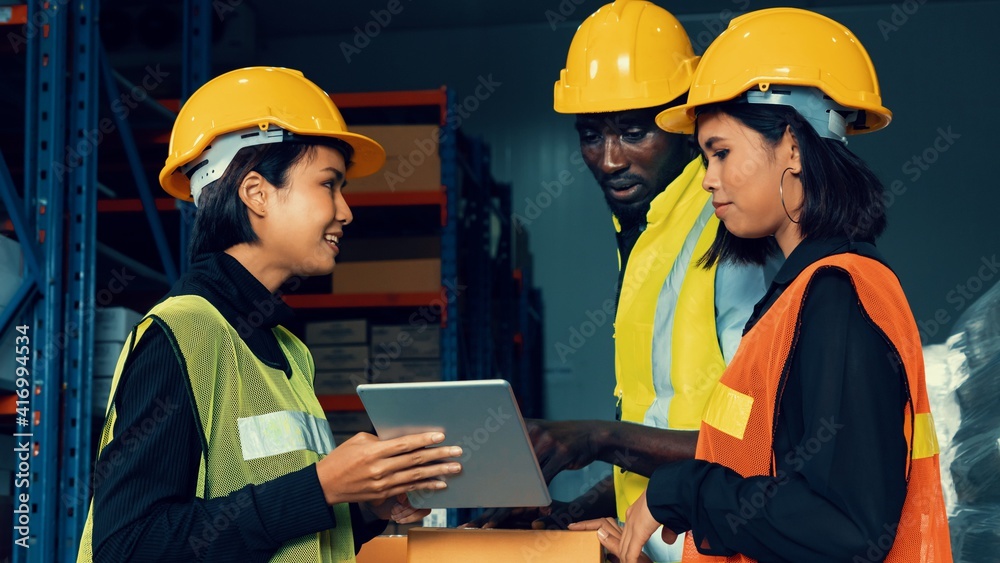 Warehouse worker working together in the storehouse . Logistics , supply chain and warehouse busines