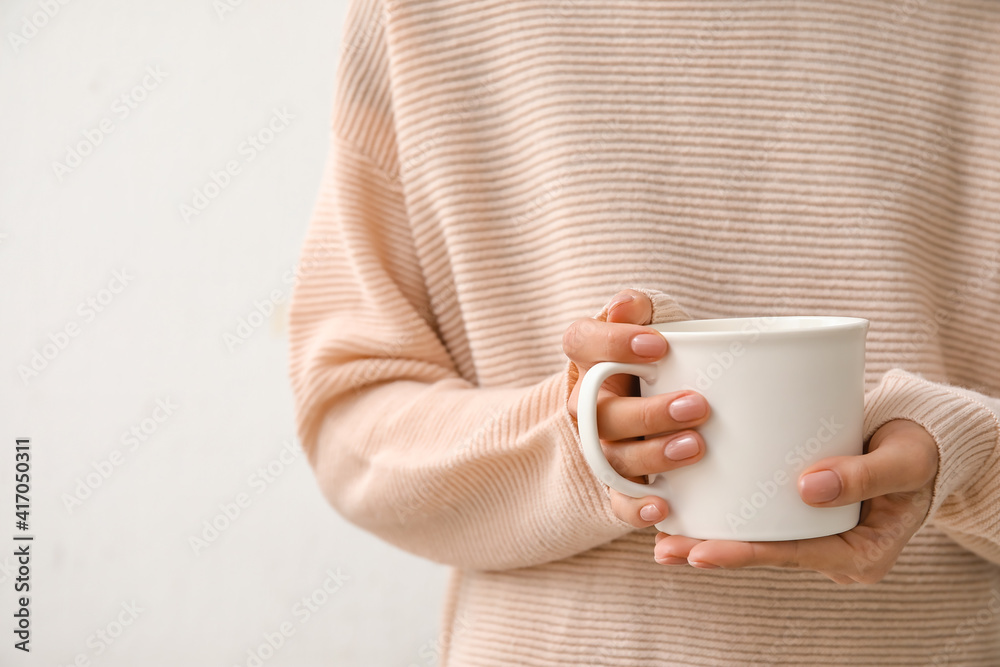 Woman with cup of hot tea, closeup