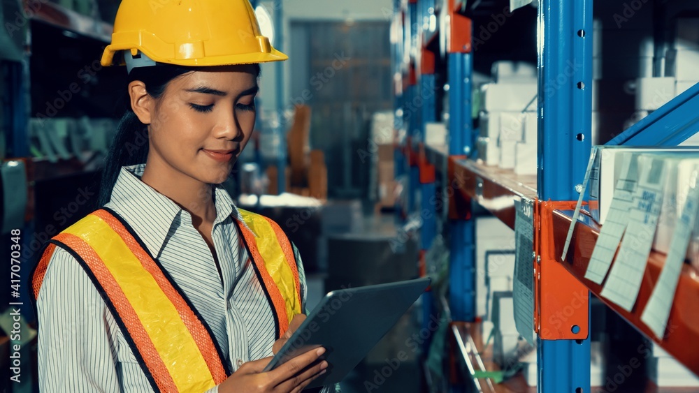 Female warehouse worker working at the storehouse . Logistics , supply chain and warehouse business 