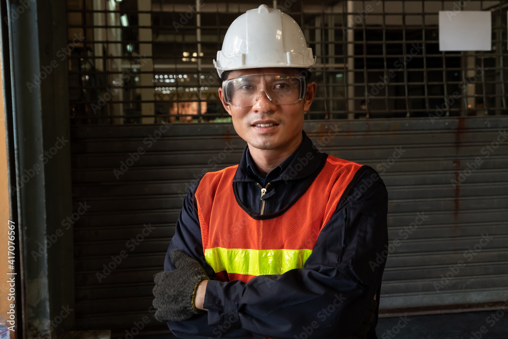 Young factory job worker or engineer close up portrait in manufacturing factory . Industry and engin