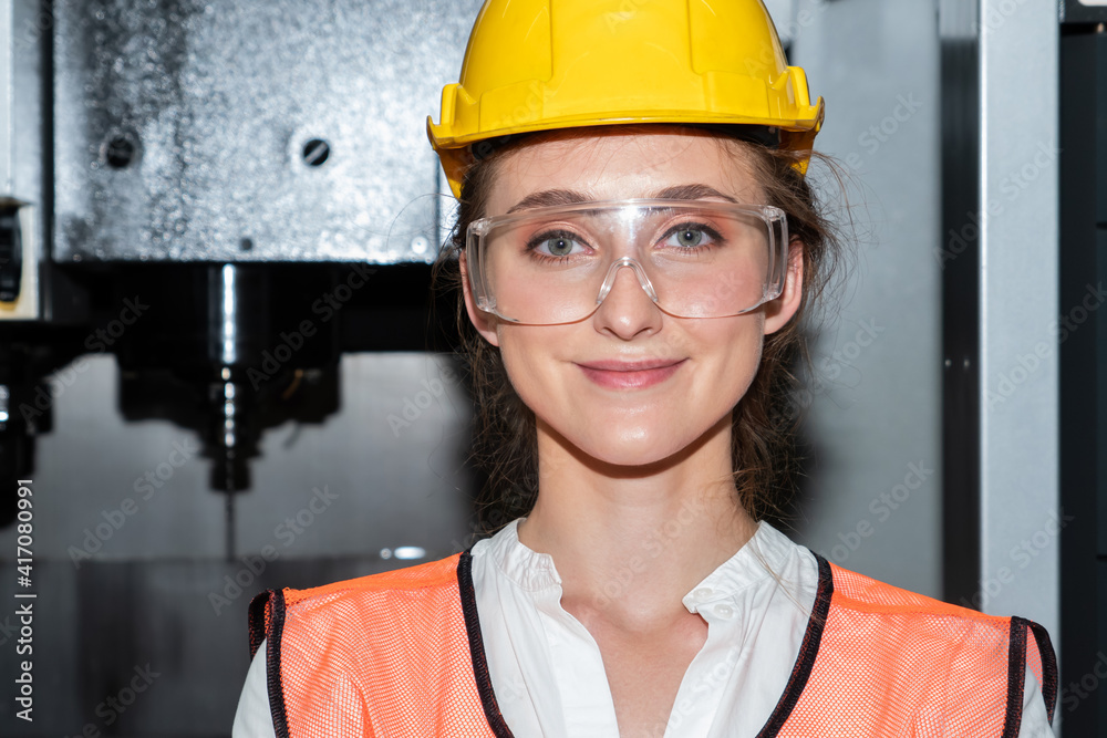 Young woman factory worker close up portrait in manufacturing job factory . Industry and engineering